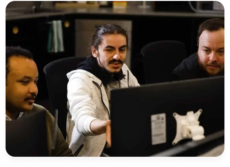 Interns working at computer screen