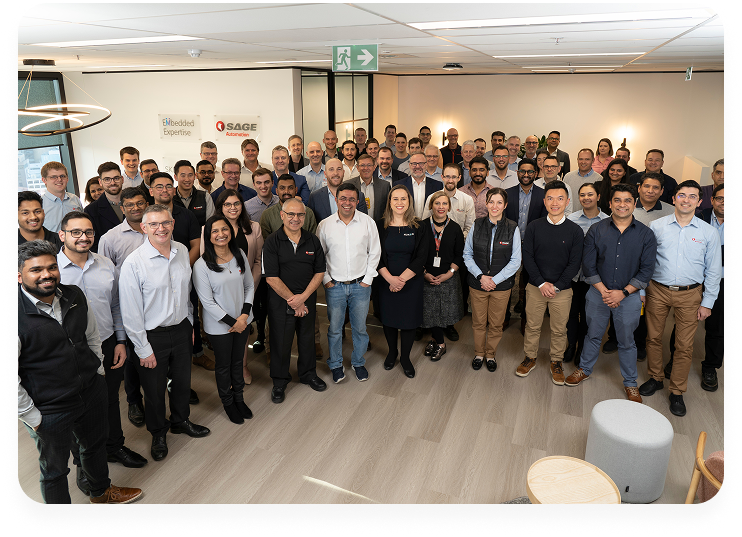 SAGE company team photo with diverse group of employees and staff members gathered in modern office space for corporate group portrait
